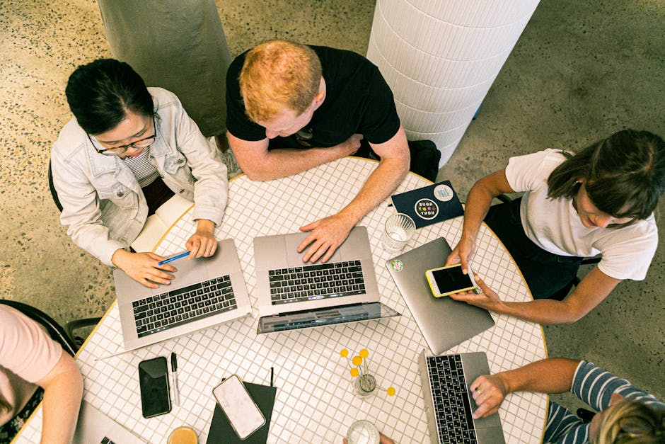 Top view of diverse team collaboratively working in a modern office setting