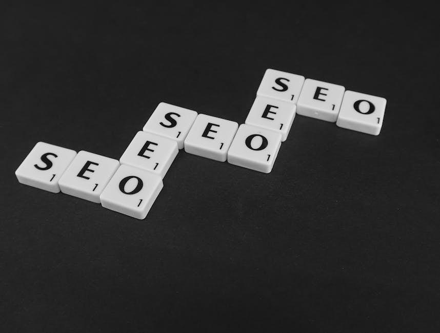 SEO spelled with Scrabble tiles on a black surface, representing search engine optimization concepts